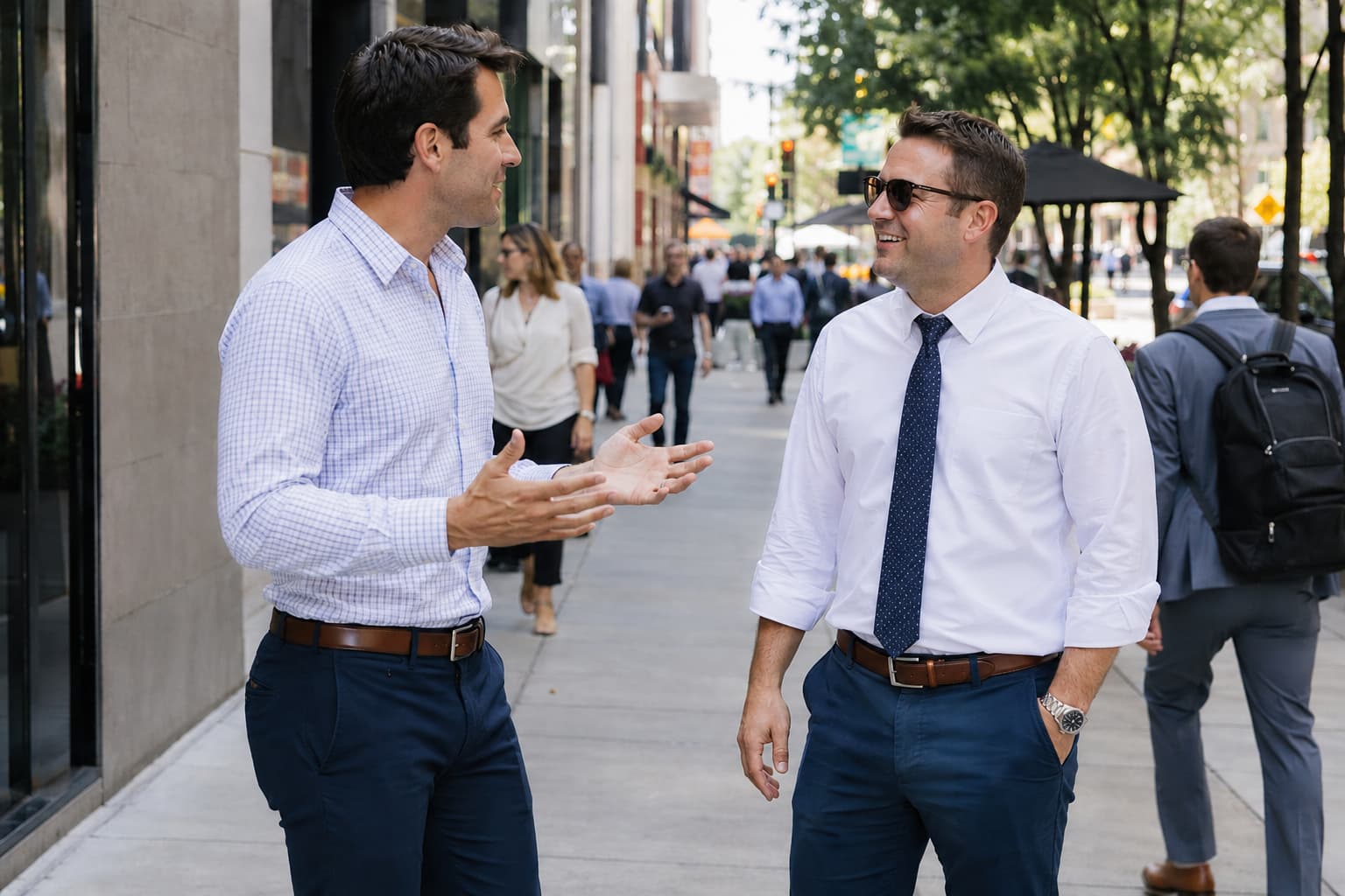 Two businessmen talking on city sidewalk